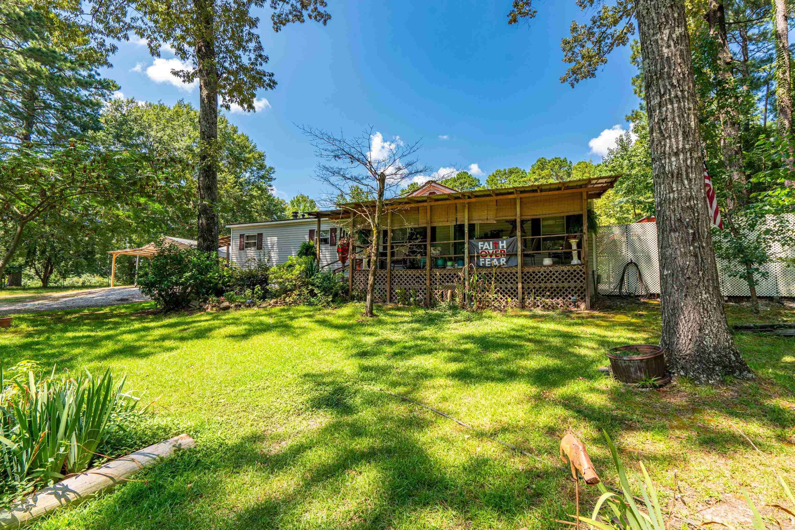 This property is a great Lake DeGray get away or a forever home! Sitting on two lots, it hosts a 1,568 sq foot 3-bedroom 2 bathroom double wide home with attach front and back porches, a 30 X 40 metal shop with electric, storage building and multiple other side-sheds. Great property and at a great price! Call today for a showing.