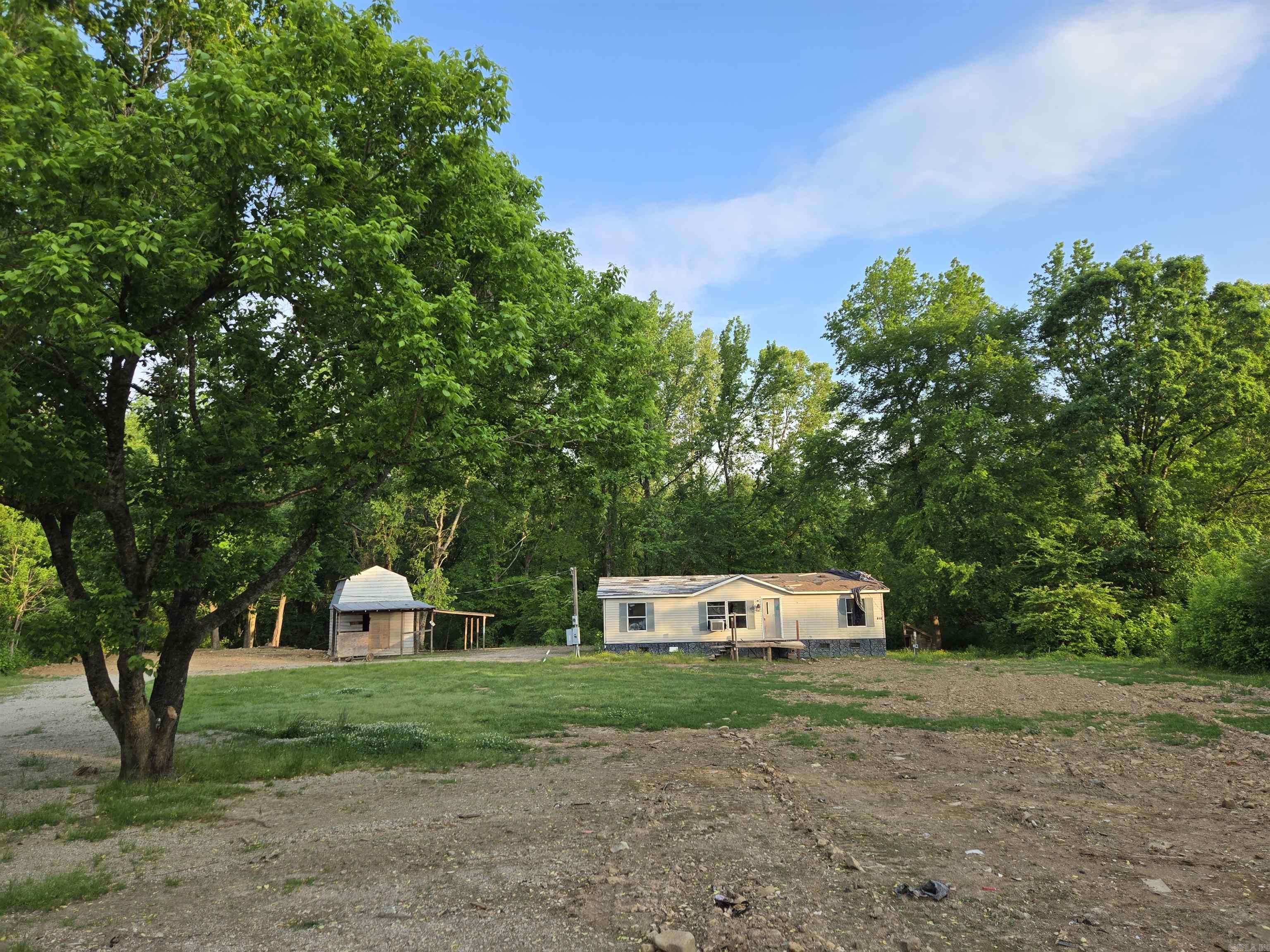Beautiful Land for sale with a small barn/shop! Land borders creek! Old abandoned and damaged mobile home is 1999 and very damaged and exposed to weather. Front Steps not safe to use. Please call for more information.