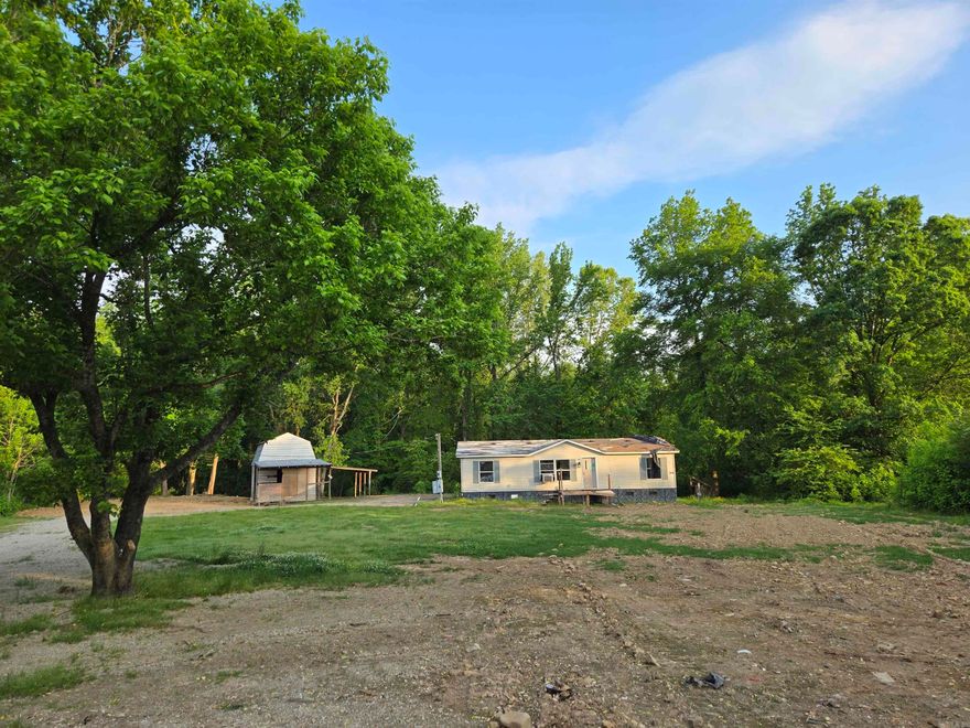 Beautiful Land for sale with a small barn/shop!  Land borders creek!  Old abandoned and damaged mobile home is 1999 and very damaged and exposed to weather.  Front Steps not safe to use.  Please call for more information.
