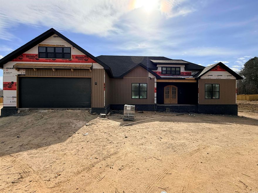 This modern new construction home is in the early stages of building and is dry and easy to show. Designed with an expansive open-concept layout, the living room, kitchen, and dining area flow seamlessly together. A large waterfall island anchors the space, complemented by a striking accent wall in the living room. Stone pendant lighting and a statement wood chandelier add warmth and architectural interest throughout.  The split floor plan offers privacy and functionality, along with a convenient half bath for guests. The primary suite feels truly spa-like, featuring a stunning tiled walk-in shower, soaker tub, dual vanities with knee space, and an oversized closet complete with built-in dressers.  This home offers flexible living options—either a four-bedroom layout or three bedrooms with a dedicated office. Additional highlights include a butler’s pantry, a functional locker/drop zone area, and a spacious laundry room with room for a folding table and hanging rack.  Enjoy outdoor living on the large covered back patio with a cozy fireplace—perfect for entertaining or relaxing year-round.