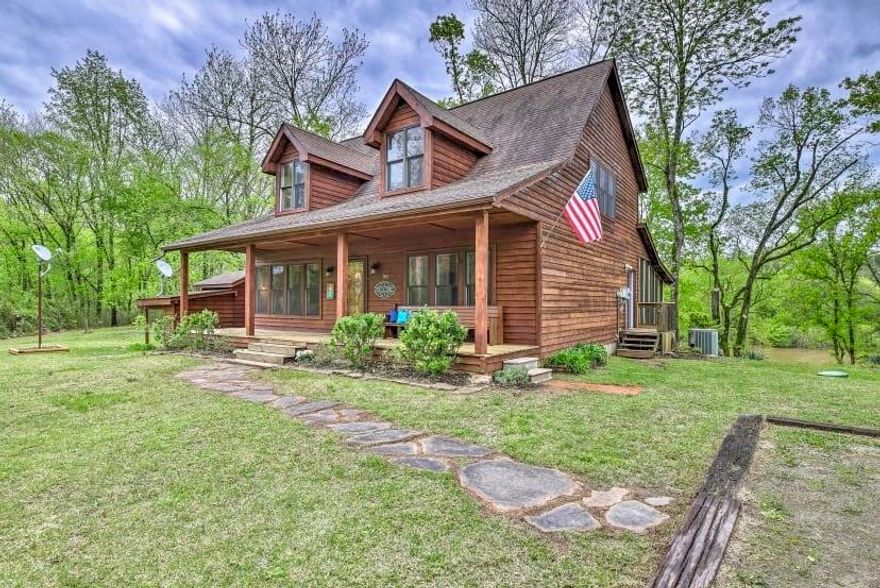 CABIN ON THE WHITE RIVER IN CALICO ROCK! This charming 2 bedroom, 2 bath retreat with an open loft, currently operating as a successful vacation rental, comes fully furnished! The cabin features an open floor plan with a spacious living area with vaulted wood ceilings and a gas log fireplace. The kitchen is fully equipped with stainless appliances, island, and lots of storage space. The master suite offers a walk in closet, sitting area, and a full bathroom with a walk in shower and a claw foot tub. Outside the cabin is a massive screened in porch for entertainment, a firepit area, and easy access to the river for fishing! Call to make this cabin your private getaway!