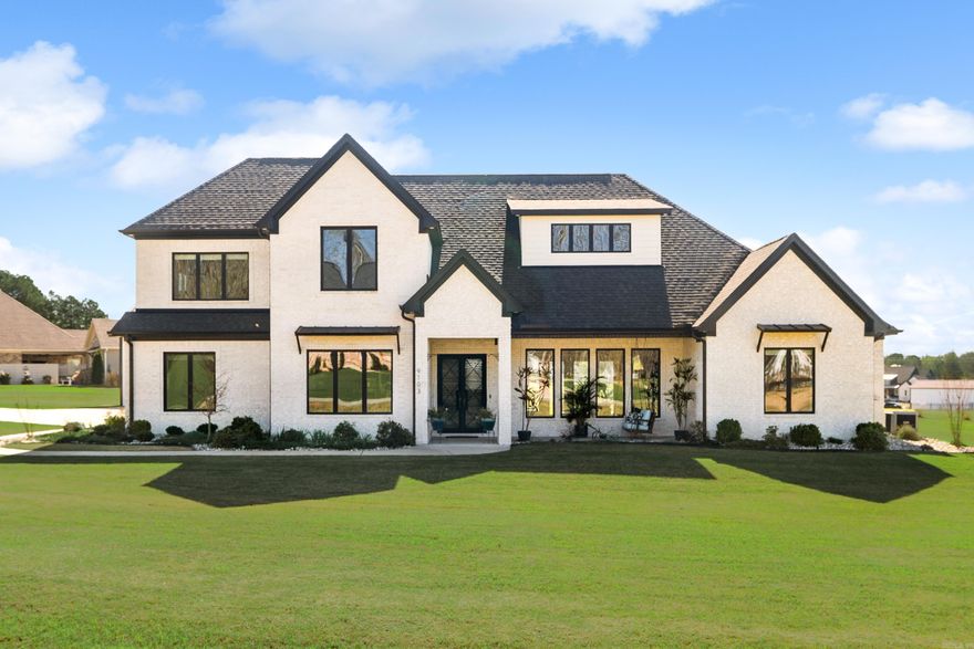 Immaculate modern farmhouse in a gated subdivision on just over an acre. From the moment you arrive, the double iron front doors, gabled entry, & charming front porch set the tone for this exceptional home. Inside, you’ll find open-concept living, 12-foot ceilings, stone-accent fireplace, cabinetry, stained floating shelves, & abundant natural light pouring through tinted picture windows. A chefs dream kitchen- featuring contrasting black & white quartz countertops, double fridge/freezer (that stays!), built-in ice maker, and gas 5-burner stove—setup for everyday living and entertaining. The spacious walk-in pantry offers cabinetry, quartz, & generous shelving. Primary suite on main level is a private retreat with vaulted ceilings, back porch access, & large picture windows. The spa-like bath includes a pass-through shower, soaking tub, along with a walk-in closet. Also downstairs: a dedicated office, half bath, laundry room, & mud room. Upstairs offers two spacious en-suite bedrooms and a large bonus room that can be a 4th bedroom, media space or playroom. 3-car garage plus a 30x32 shop- ideal for hobbies or storage. Thoughtful details, premium finishes, & room. Truly a must see!