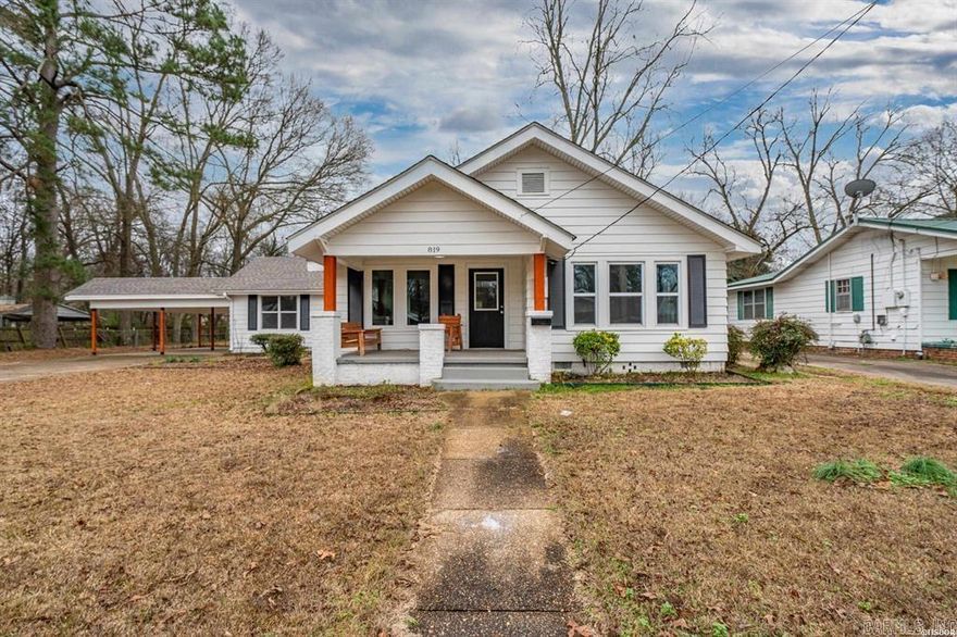 This beautifully refreshed 3-bedroom, 2-bath home is move-in ready and designed with family living in mind. Multiple living areas provide the perfect balance of shared spaces and room to spread out. The oversized living room welcomes you with original built-ins and a decorative fireplace, adding warmth and character. Luxury vinyl plank flooring flows throughout the home, offering a stylish, kid- and pet-friendly, low-maintenance finish.  The kitchen is designed with family life in mind, granite countertops, new cabinetry, gas range, large sink, and breakfast bar—perfect for homework time, quick meals, or gathering together. Just off the kitchen, a flexible den provides the ideal spot for a playroom, homework area, home office, or additional family space.  Two guest bedrooms and a spacious full bath are located on one side of the home, while the private primary suite is tucked away, offering parents a quiet retreat. A generously sized laundry room leads to the large backyard, giving kids and pets plenty of room to run, play, and enjoy the outdoors. Energy-efficient new windows help keep utility costs down, and the 2-car covered carport adds everyday convenience.