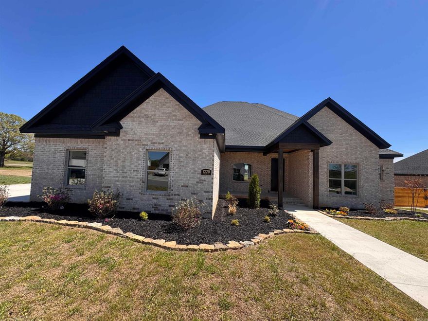 This brand new home features bright, open spaces in the main living area, featuring 10 ft tall ceilings, while 8ft tall doors and windows that look to the back yard and covered patio. The kitchen is a true standout, featuring a large center island and flat panel style white oak cabinetry with black appliances and gas cooktop. A pantry is located just off the kitchen. This smart split floorpan is also designed for comfort & privacy. The primary bedroom is just off the living area, and includes an en-suite bath with free-standing tub and custom tile shower. A large closet has lots of shelving and a window for light. A guest suite is located near the entry, along with a full bath. There are two large bedrooms on their own side of the home, along with the 3rd full bath. The same hardwood-style LVP flooring flows through all areas. There's an extra golf cart garage with overhead door, in addition to the 2-car side loading garage. Located on the edge of town is the perfect balance of convenience, comfort, and quiet living.