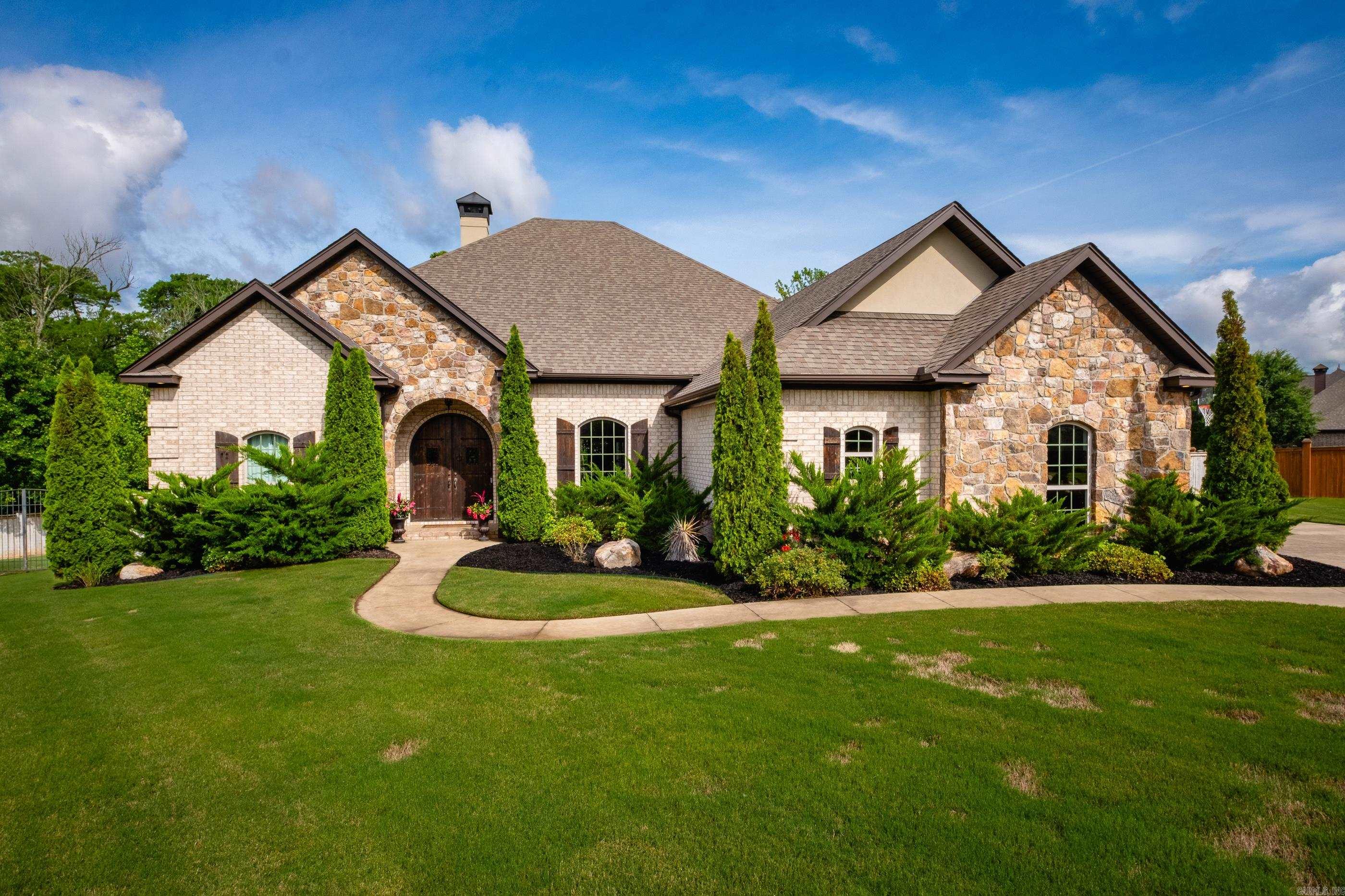 Amazing one-level custom home by Lynn Dickey, perfectly positioned on a quiet cul-de-sac and backing to greenspace for ultimate privacy. Enjoy year-round outdoor living with a heated saltwater pool, remote-controlled lighting, three gas firepots, and a rock gas fireplace on the covered patio. Inside, the open floorplan features double wood front doors, hardwood floors throughout (tile in baths and laundry), a dedicated office, game room, formal dining, and an eat-in kitchen with breakfast bar, gas range with griddle, and ice maker. The spacious primary suite includes a fireplace, double-entry walk-in shower, soaking tub, dual vanities, and two large closets. The laundry room offers built-ins, a sink, folding space, and storage. Additional features: 3-car side-load garage, extra parking, mosquito misting system, and sprinkler system. Gorgeous landscaping completes this private oasis. A rare find!