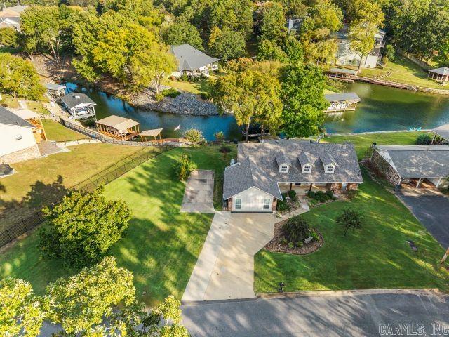 LAKE HAMITON!! Close to everything, downtown Hot Springs, Oaklawn , restaurants and shopping. Home has been totally updated, also has added another Primary bedroom with its own bath. Other two bedroom share a bath. LVP flooring, kitchen has island with new countertops, granite and appliances. Kitchen over looks great room with fireplace. Has extra parking and large side yard. Beautiful covered back porch overlooking lake with boat dock. All furniture conveys with acceptable offer