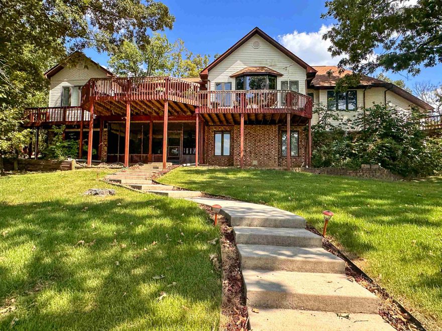 Spacious Custom Lakefront Home...On two of the best Crown Lake lots to be found. From the office to 5 Bedrooms, multiple living areas, formal dining plus breakfast bar, two eat-in kitchens, porches, decks, patio, private dock & boat launch, RV hookup, garage, extra storage, fabulous sunsets and parking galore, you can live the dream. Beautiful tile, hardwood, granite, vaults, cabinets, laundry areas, sitting & bonus rooms. Minutes to dining, groceries, marina & health care.