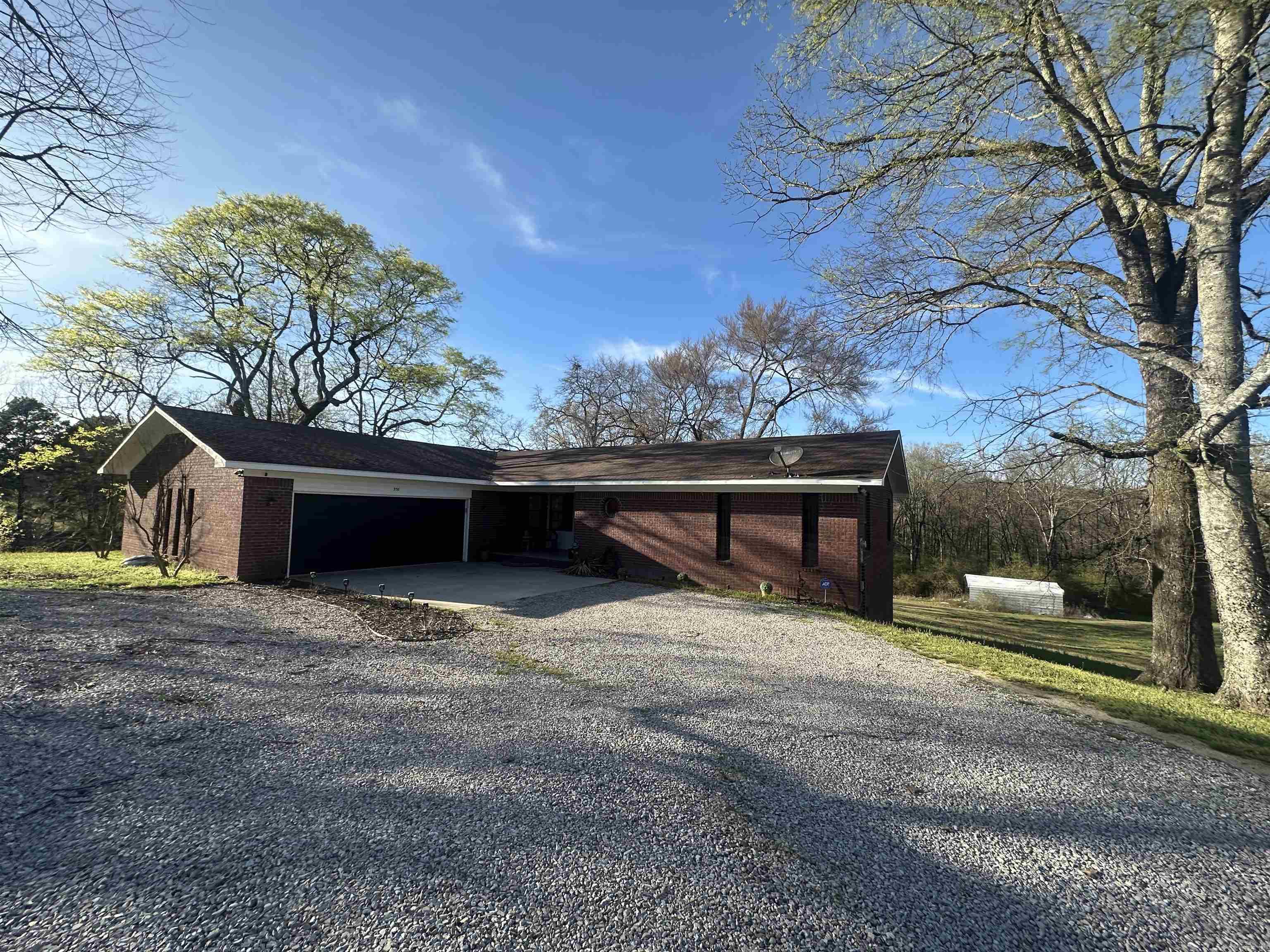 Discover the perfect blend of space, comfort, and functionality with this stunning two-story brick home set on 5.98 Acres with a large stocked pond just outside the city limits. This property offers the peace and privacy of country living while still being conventionally located. This property features an oversized garage (newly done in 2024) with a storage room on the house and an enclosed shop with a bathroom, plumbing, heated and cooled, and electrical. With Nearly 6 acres of land, there's plenty of room for outdoor activities, gardening, or future expansion. If you're looking for a home with acreage, functional amenities, and no city restrictions, this is the one!
