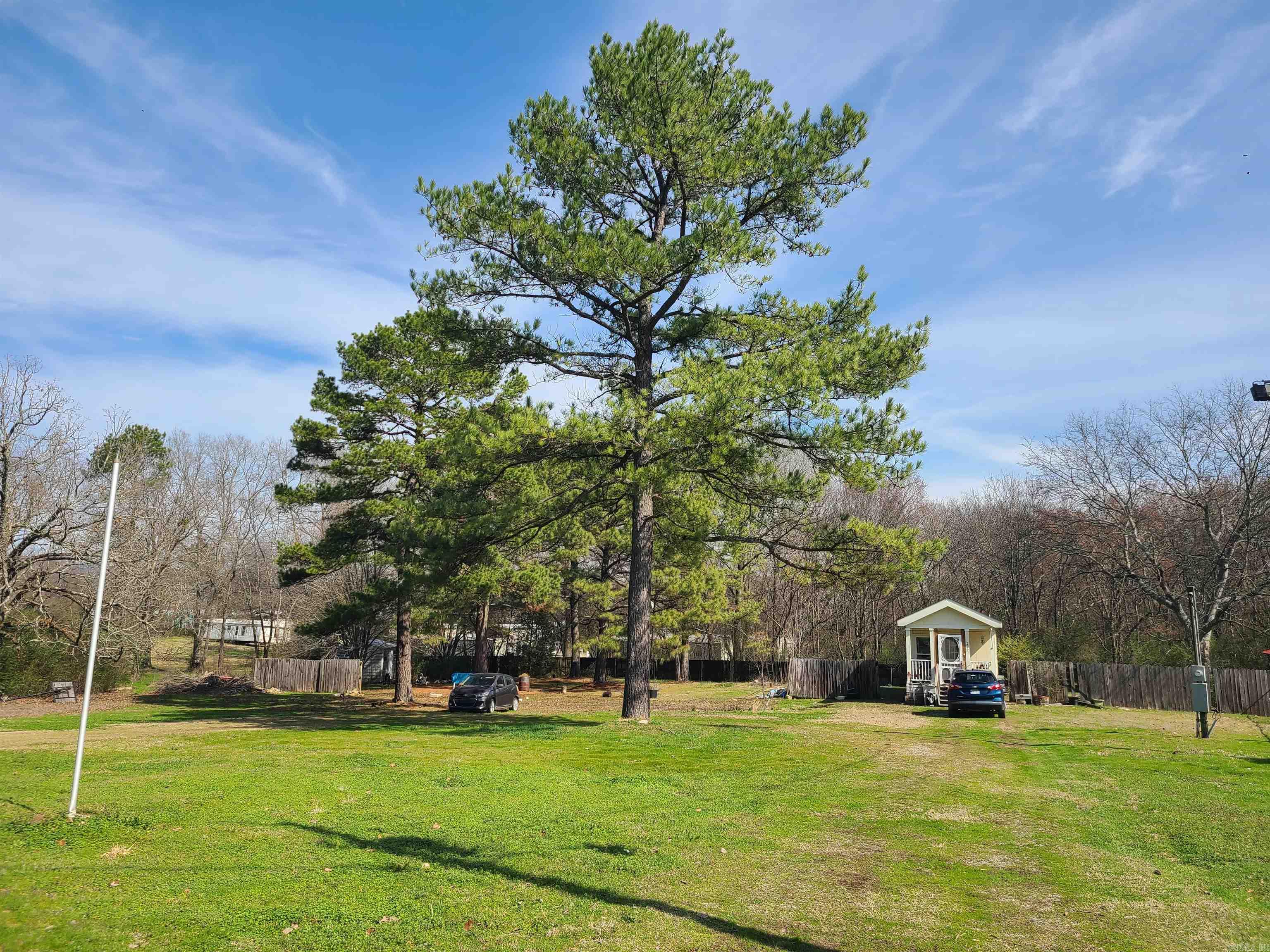 Check out this charming tiny home nestled on just under an acre of land. This cozy 400 sqft home features 1 bedroom and 1 bathroom, making it an ideal retreat for those seeking simplicity and tranquility. Also enjoy the convenience of established hookups for electric, water, and gas, which are already on the property, making it easy to expand your living space. There is ample room to build on or even add a mobile home. This property has a circle driveway with lots of parking space. Storage building, tabletop dishwasher, refrigerator, and stove convey.