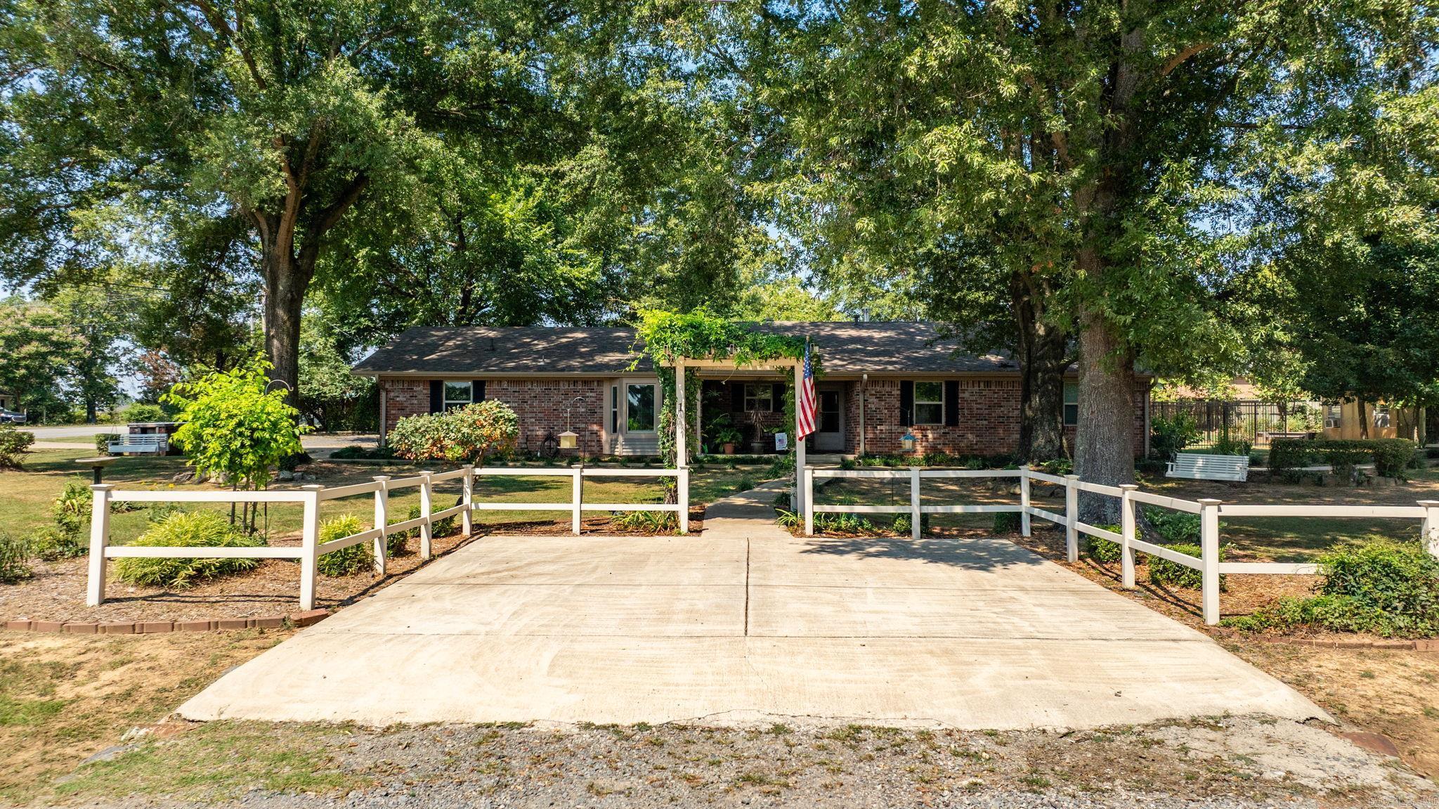 Welcome to this unique and beautifully maintained property offering spacious main home (1929 sq ft) and fully equipped mother-in-law cottage (866 sq ft), perfectly situated on a large 1.18 acre corner lot. The main home features an inviting layout with a cozy wood burning fireplace, a beautifully updated kitchen with white cabinetry, stainless steel appliances, built-in cooktop, and stunning brick backsplash. Enjoy meals in the dedicated dining room or relax in the sunroom at the back of the home. The bedrooms offer carpet and tile in wet areas, wood flooring in living areas. Updated guest bathroom, includes soaker tub and custom shower. Laundry room with lots of storage. Step outside to enjoy the brick pathway, patio area, and fire pit. Separate mother-in-law is equally impressive, with its on private entrance, covered carport, washer/dryer, custom shower, and walk in closet, perfect for guests or multigenerational living. This one -of-kind property offers offers flexibility, comfort, and style in every square foot. Don't miss this opportunity to make it yours-- schedule a private showing today!