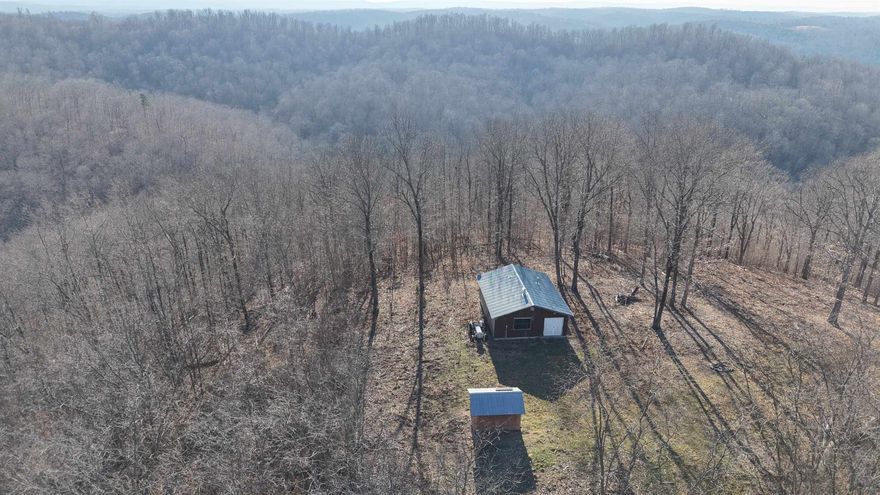 This 115 +/- acre property offers a rare opportunity to own a secluded mountain top retreat in the heart of the Ozarks.  Conveniently located between Melbourne and Mountain View, Arkansas, the property is accessed by a rural easement road and provides the ultimate privacy. Less than two miles from river access, the cabin also offers a scenic river view, adding to the unique appeal of this land. The property includes an off-grid 1-bedroom, 1-bathroom cabin, providing a great start for those looking to homestead, establish a hunting camp, or enjoy a simple and rural getaway. With no restrictions on the land, there are multiple options for future use, whether recreational or residential. Outdoor enthusiasts will appreciate the maintained trail system throughout the property, making it easy to explore. Abundant wildlife, including whitetail deer, bear, turkey, and small game, make this an excellent investment for hunting and outdoor recreation. This Ozark Mountain property is listed for $259,900.