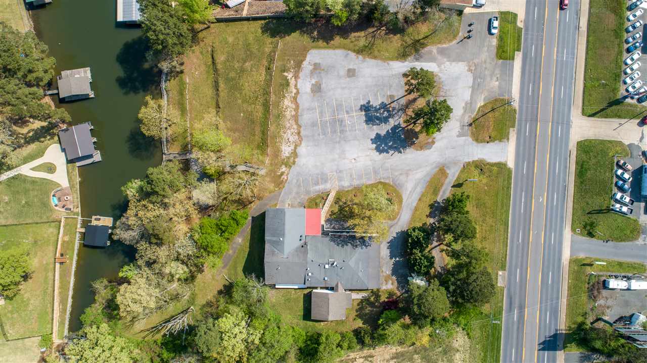 This prime lake-front commercial property offers many options & tons of potential. With high visibility & a traffic count of 35,000 cars per day, you won't find a better place in Hot Springs for your business. 2.6 acres offers plenty of room for development & would allow for subdividing and/or multiple building sites. The 380 feet of Lake Hamilton frontage includes a boardwalk with tie-up for 10 boats (per Entergy) & a 22X48 entertainment deck on the water's edge. Don't miss this opportunity!