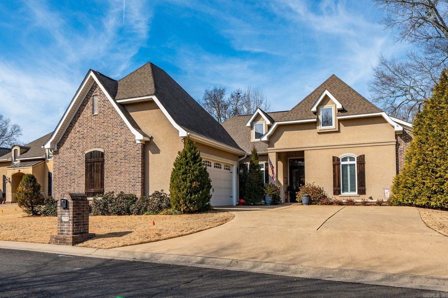 Experience refined living at 104 Bella Court. This elegant single-level residence, built in 2010 and nestled within the desirable Bella Court Subdivision, offers approximately 2,520 sq ft of thoughtfully designed space. The split floor plan features 3 bedrooms, 2.5 baths, and a dedicated office, creating an ideal blend of comfort and functionality. Step inside to find beautiful crown molding, two gas fireplaces, and an inviting open-concept living area perfect for both everyday living and entertaining. The home showcases a sophisticated mix of hardwood, tile, and carpet flooring, along with custom Venetian blinds and a generously sized laundry room. The heart of the home is the gourmet kitchen, complete with a large pantry, granite island, custom cabinetry, gas range, double sink, and a charming breakfast nook. Granite countertops continue throughout all bathrooms, adding a cohesive touch of luxury. Additional highlights include a large two-car garage with floored attic storage, offering both convenience and practicality. Situated in a prime location near the hospital, shopping, and the vibrant charm of downtown Hot Springs, this home combines upscale living with everyday ease.