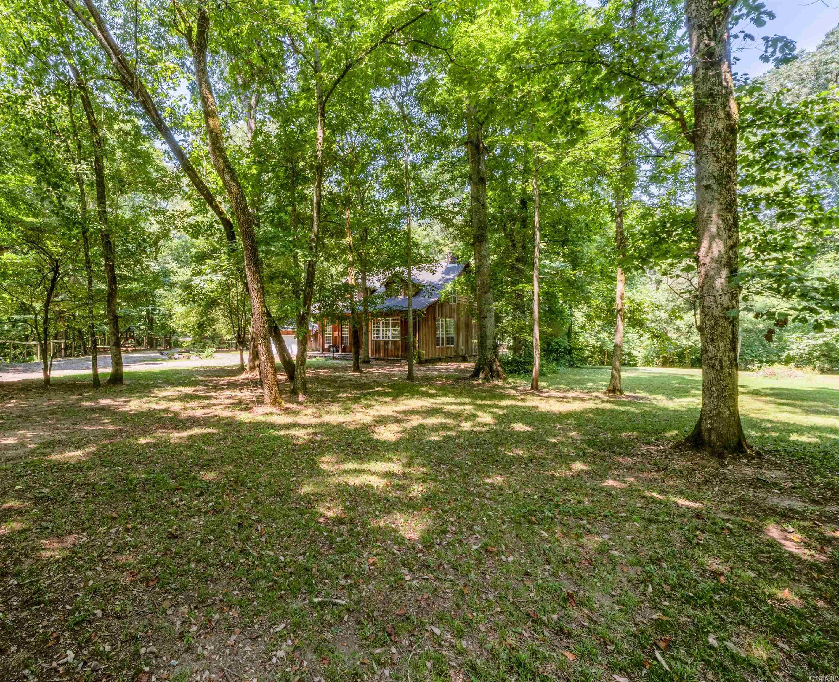 Craving solitude and Mother Nature's embrace? This custom cabin perched on the Little Red River is the stuff of fairy tales! Nestled in a gated community just a breezy 15 minutes from Searcy, itās where rustic charm meets luxury. Picture this: an open floor plan with a rock fireplace, serving up river views thatāll make your heart skip a beat. Relax on the screened-in back deck, or set sail from your private boat dock. Built like a fortress with solid beams, foam insulation, and a hurricane-proof roof, this gem boasts 14-foot ceilings and grand 8-foot solid-core doors. NO Flood insurance for this riverfront property!!!