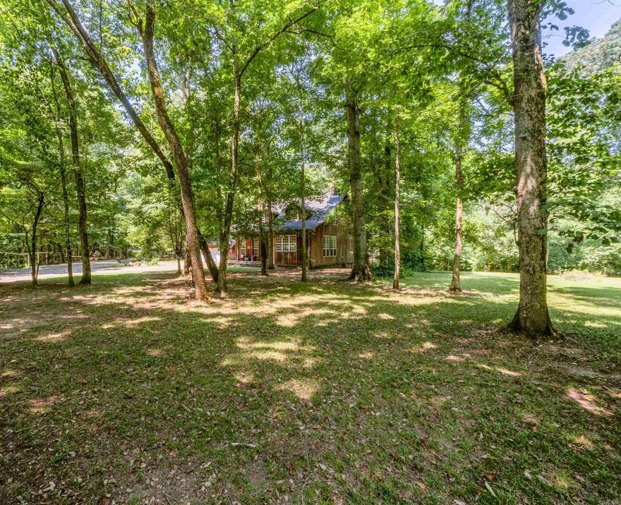 Craving solitude and Mother Nature's embrace? This custom cabin perched on the Little Red River is the stuff of fairy tales! Nestled in a gated community just a breezy 15 minutes from Searcy, it’s where rustic charm meets luxury. Picture this: an open floor plan with a rock fireplace, serving up river views that’ll make your heart skip a beat. Relax on the screened-in back deck, or set sail from your private boat dock. Built like a fortress with solid beams, foam insulation, and a hurricane-proof roof, this gem boasts 14-foot ceilings and grand 8-foot solid-core doors.  NO Flood insurance for this riverfront property!!!