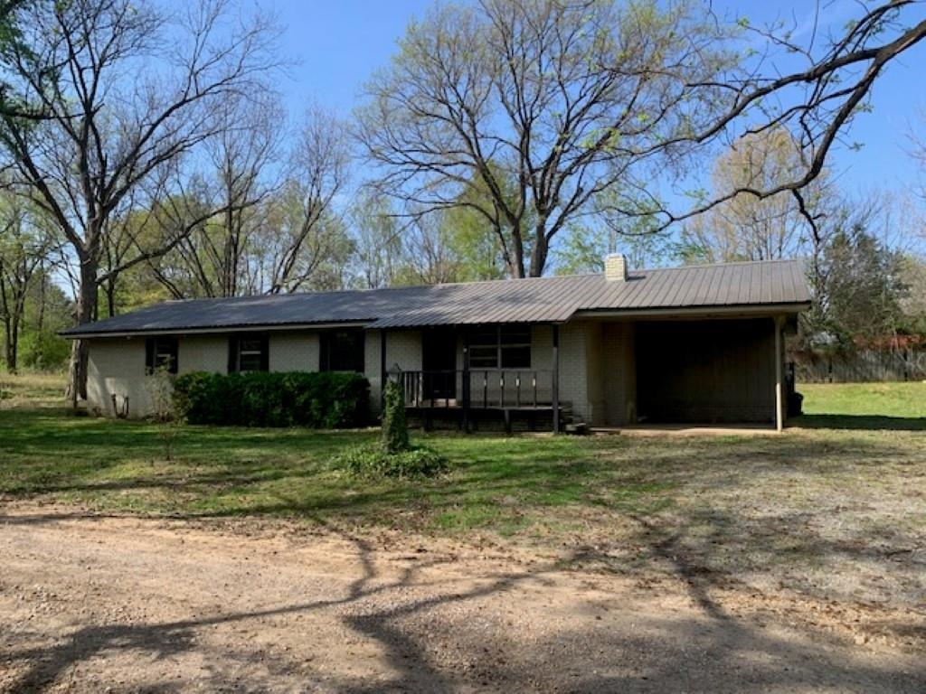 Enjoy country living with this 3 bedroom 2 bath home, or 2 bed, 2 bath with a movie room. Stay cozy beside your fireplace or enjoy the evening on your covered porch. This 8 + acres even has room for your personal deer stand. Located just a few miles from "Old Grand Glaise" White River Access. This property could be a great "getaway" property for duck hunters, deer hunters, or fishing enthusiasts. Call today for your personal tour. Property to be sold as/is, where is, all faults.