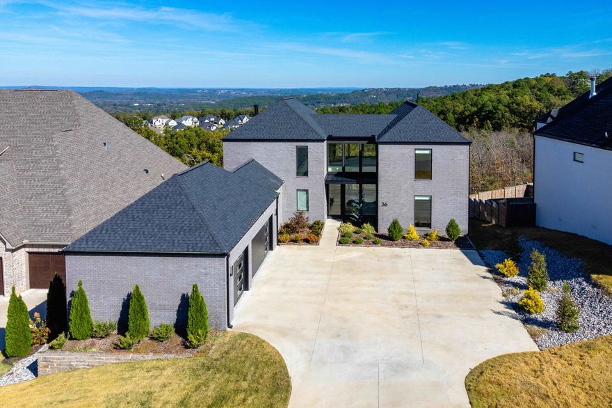Experience luxury and modern sophistication in this custom-built masterpiece! Enter through a grand, two-story foyer, highlighted by a striking floating staircase and sweeping views that set an elegant ambiance. The open-concept floor plan seamlessly connects the living, dining, and kitchen areas, all framed by breathtaking views of Pinnacle Mountain from the main living space. Step out onto an expansive deck, perfect for relaxation or entertaining against a stunning natural backdrop. The chef’s kitchen is a culinary haven, featuring custom cabinetry, premium stone countertops, and high-end appliances that make cooking a delight. The primary suite serves as a spa-like retreat with a custom-tiled walk-in shower, jetted tub, and upscale finishes. Each additional bedroom includes a private en suite bathroom, ensuring both comfort and privacy. An additional flex room—ideal as a sixth bedroom, office, or lounge—boasts glass doors that showcase the home’s stunning vistas. This home epitomizes the perfect blend of beauty, convenience, and prime location, delivering a truly unparalleled high-end living experience.