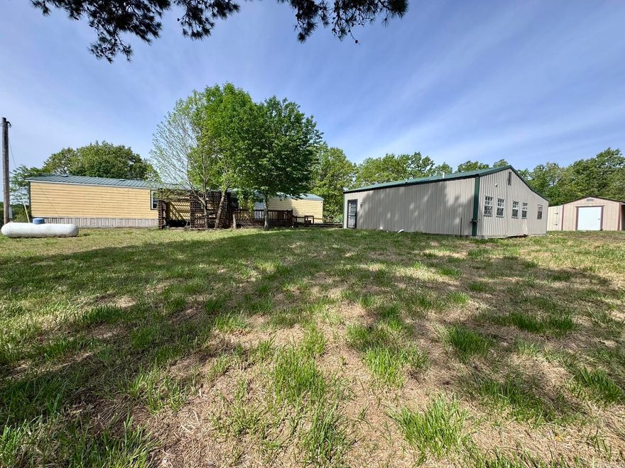 This property resides on 4.97 acres in the Pine Tree 2nd Addition subdivision of Oxford, Arkansas. It offers a 2-bedroom, 2-bathroom manufactured home with 1,008 square feet of living space, along with a versatile barndominium-style livable shop that includes 2 bedrooms, 1 bathroom, and 896 square feet. This unique setup provides excellent flexibility for guests, extended family, or potential rental income.  The property features an in-ground manufactured storm shelter, a large yard, a scenic pond, and a lawn mower shed with a lean-to for additional storage. Whether you're looking for a multi-use property, a small homestead, or a country home with room to spread out, this listing offers it all for only $139,900.