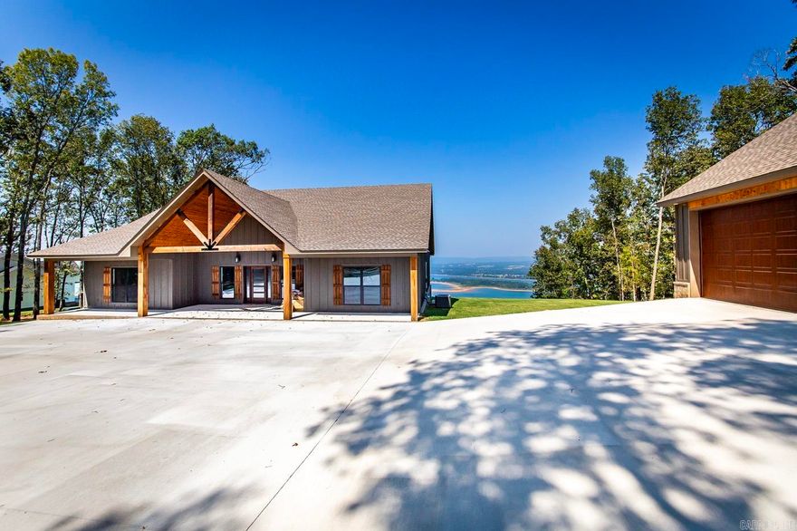 NEW HOME (built in 2023) with the most beautiful views of Greers Ferry Lake that you'll ever see!  Sitting on a large 3-acre wooded lot in a new 6-lot subdivision overlooking GFL and the Narrows to the north.  Open floorplan with vaulted ceilings and exposed beams, LVP flooring that matches the rustic setting, large covered pack porch that flows perfectly from the interior living space!  Lovely open kitchen with lots of cabinetry, large island with breakfast bar, and stainless appliances!  Primary bedroom has wonderful views of GFL, spacious walk-in closet, walk-in shower and separate tub plus his and hers vanities.  3-car garage is HUGE...perfect for lake toys and/or a multi-functional game room/"fun" space!  A lovely home in a very special setting!