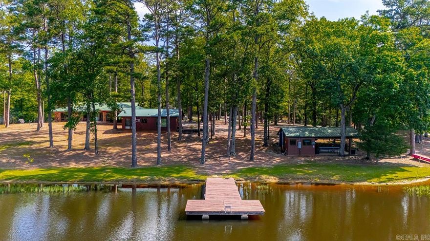 Located on 27acres (19 wooded) this unique property sits on Henry Lake. Stone entrance leads to huge carport of 2272sq.ft. 3bd/2ba main home w/tongue & groove pine wood, massive stone fireplace, wall to wall picture windows w/15ft. vaulted ceiling & expansive views of the lake. Eat-in kitchen w/dark stained lower cabinets & open uppers, updated fixtures & farm sink, huge walk-in pantry & laundry room w/sink-tons of storage! The spacious master bedroom suite has double closets & large picture windows with lake views & access to porch area. 2nd bath includes double sinks, tub & walk-in shower flanked by 2 extra bedrooms w/gorgeous windows overlooking lake w/lots of closet space. 640sq.ft. lakeside 1bed/1ba guest house: living room w/fireplace, kitchenette. “The Event Center” pavilion, 16x20 shop(water & electric) swimming dock w/room to kayak/canoe, fishing, campfires and room to explore. If you are looking for a peaceful retreat (or) maybe interested in building a few more cabins and getting into renting Airbnb’s (or) possibly opening an RV park-let’s go take a look at this outstanding property! The possibilities are endless.