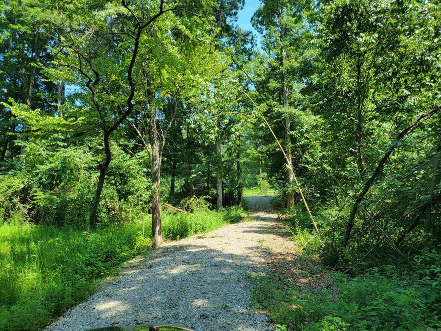 Welcome to this stunning piece of land! Nestled outside of city limits, this property offers a breathtaking landscape with a plethora of majestic Red & White Oaks scattered throughout. As you enter, a well-constructed gravel driveway ensures a smooth and easy access. The property has water availability, adding to its convenience. An enchanting stream meanders through the land, enhancing its natural charm.  Endless possibilities await you here – whether you dream of building your own idyllic retreat, embarking on thrilling hunting adventures, or envisioning a captivating RV Park, this land provides the canvas for your imagination to run wild. Don't miss the chance to explore and claim this slice of paradise as your own!