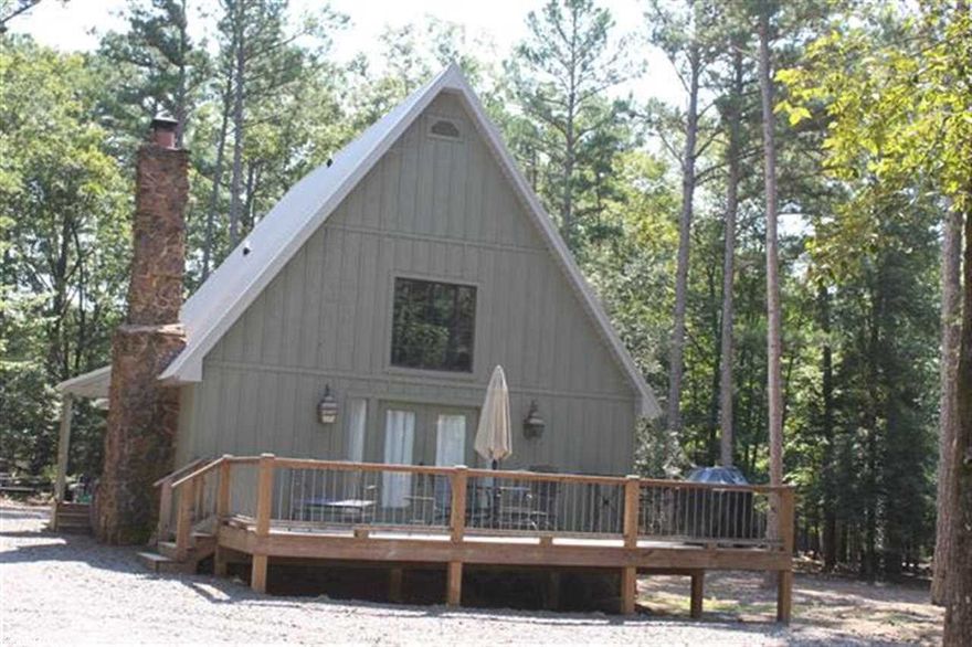 Totally remodeled and updated 4 years ago, this charming and cozy house is ready to move in today.  1 year old metal roof, Stainless Steel Appliances, Granite counter tops, Hardwood Floors are just a few of the recent updates.  3 bedrooms, 2 full baths, large open Living/Dining/Kitchen with Vaulted Ceiling.  Ozark Native Stone fireplace with Gas Logs.  2 Large ext. decks great for entertaining.   Short distance to the Golf Course, Boat Ramps and within walking distance to the Tannenbaum Rec area lake access