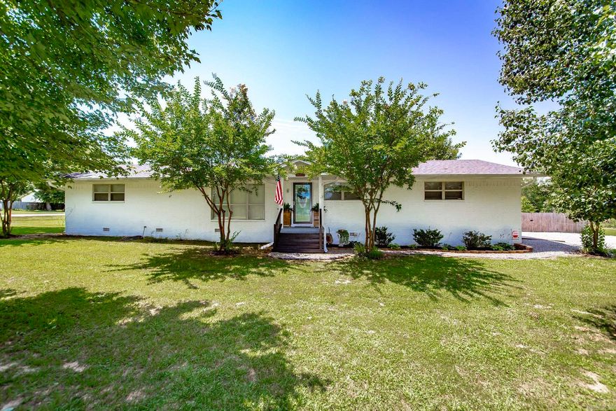 Welcome to your new haven! This picturesque white brick home exhumes charm and character. As you approach, a delightful path leads you from the side-entry 2-car garage to a cozy front porch, all framed by large, mature trees. Inside, the living room welcomes you with abundant natural light and a seamless view into the dining room, perfect for entertaining. Rich hardwood floors flow throughout, accentuating the neutral tones of the walls. The kitchen you will find just off the dining room at the back of the home. Featuring stainless steel appliances, white cabinets and granite countertops. Adjacent to the kitchen, generously sized laundry room offers ample storage. With three spacious bedrooms and two bathrooms, this home is designed for comfort and convenience. The large fenced in backyard is complete with a deck ideal for summer gatherings and a fire pit perfect for fall evenings, leaving you with plenty room to make this space your own. This home blends classic charm with modern amenities, providing the perfect backdrop fir your next chapter. Come and experience the warmth and beauty of this home- its ready to welcome you!