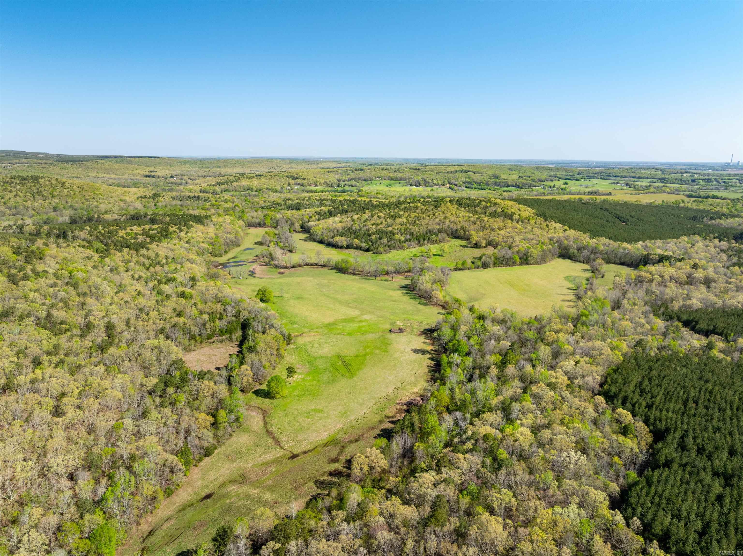 Where Adventure Meets Opportunity – Hunting & Farm Paradise Near Thida, AR Just off Thida Road sits a secluded gem—your own 130± acre getaway. With about 85 acres of lush pasture and the rest in mature woods, this property offers endless potential. Whether you're looking to run cattle, plant food plots, or simply relax in nature, this place has it all. A beautiful creek winds through the land, complete with a large swimming hole and plenty of bottomland perfect for food plots. Deer, turkey, and even bear travel this creek, making it a hunter’s dream. There’s an established camp site already in place with buildings and electricity run to them (powered by generators). It’s ready for your weekend deer camp—or the perfect spot to build that off-grid cabin you’ve been dreaming of. You’ll love the total privacy. Out here, the only people you'll see are the ones you bring. And yet, you're just: 20 mins to Bradford & Pleasant Plains 30 mins to Batesville & Newport If you’ve been searching for a place that offers pasture, woods, water, wildlife, and seclusion, look no further. This is more than land—it’s a lifestyle. Secluded, has a legal easement to property.