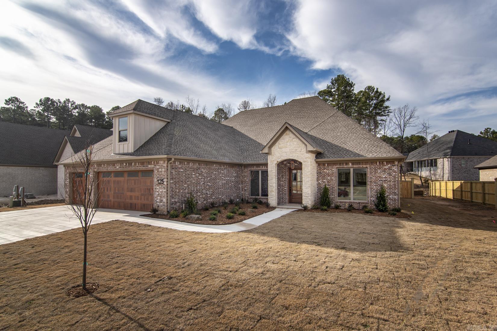 Stunning New Custom Home in Chenal Valley's Abington Court. Located just off La Marche Drive, this community boasts large, level lots that provide ample space and privacy. This custom-built masterpiece by Hartness Construction, with over 50 years of experience, presents an open and inviting floor plan ideal for modern living and entertaining. The home features a spacious great room, an open dining area, and a cozy family room complete with a beautiful fireplace. The kitchen is truly a chefās dream, equipped with high-end stainless-steel appliances, an expansive pantry, and full-size refrigerator and freezer. A well-appointed office with custom built-ins provides a sophisticated space for working from home. All three main-level bedrooms are en-suites, with the primary suite featuring a tray ceiling, a luxurious custom bathroom, and an extensive built-in closet. Upstairs, an additional bedroom and bathroom make for a perfect guest or bonus space. The large covered back porch, complete with a fireplace, is the perfect spot for outdoor relaxation, overlooking a level backyard and a lush greenbelt. Three Car Garage.