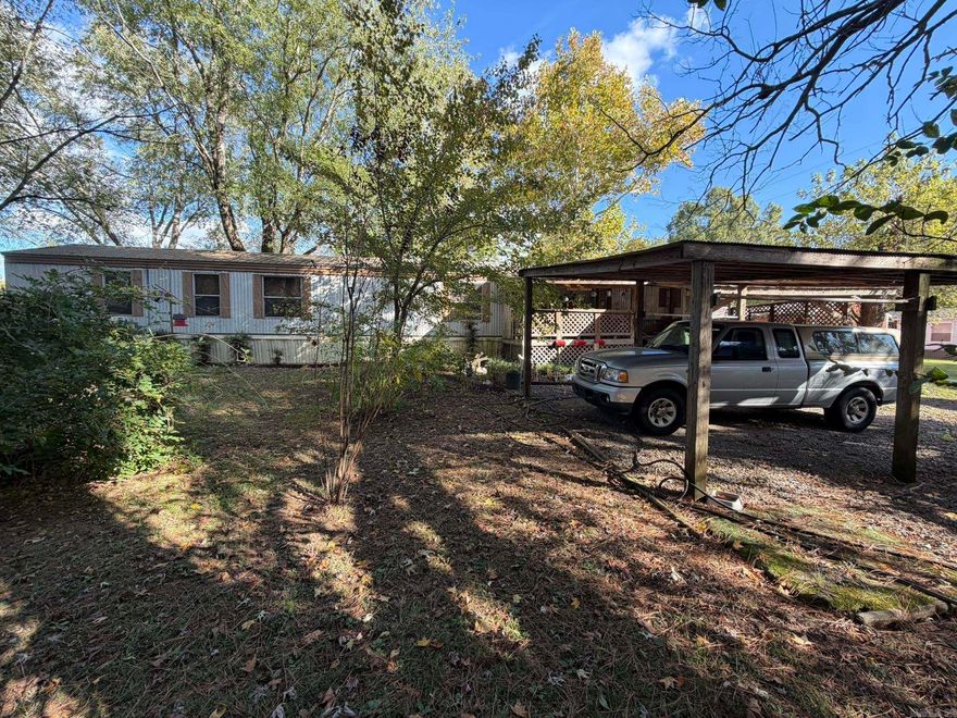 This unique property consists of three separate parcels offering endless potential. The first parcel features a well-kept mobile home currently occupied, with two covered parking areas, a storage shed, a covered front porch, and a covered back deck. The second parcel includes a spacious shop on a slab, complete with a roll-up door and electricity, perfect for projects or extra storage. The third parcel includes a 1120 sq ft 3-bedroom, 1-bath home with a little TLC, this home could truly shine along with two additional storage sheds. The property sits on a quiet dead-end road surrounded by beautiful trees and includes a nice garden area, providing a peaceful country setting.