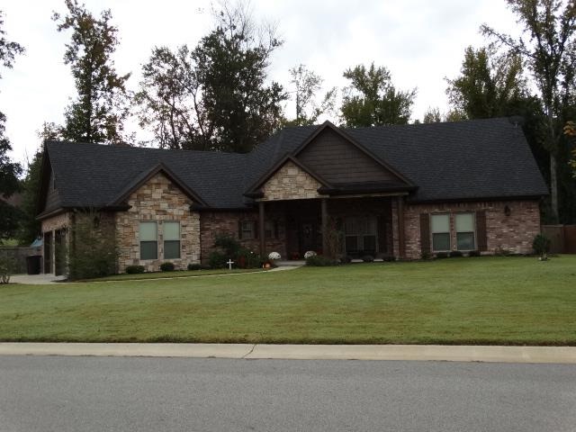 The entry to this home just invites to come in. Warm and welcoming. Beautiful open floor plan. Dining room has fireplace. Private master suite with fantastic master bath. Kitchen has all custom cabinets.This home could easily be a five bedroom bonus room has closet and private bath. Privacy fenced back yard