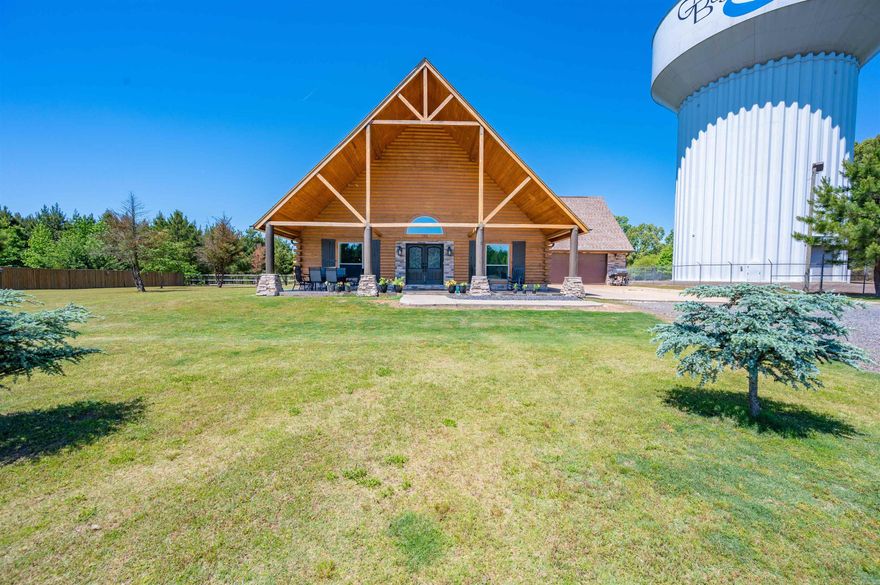 Are you looking for privacy and acreage? Need a place for horses, chickens and all the animals for farm life? Check out this stunning log home, sitting on a beautifully maintained 5.96 acres. Start your day with a cup of coffee on massive front porch. When it is time to go in, step inside the double doors to a breathtaking, open concept living area w/fireplace and a soaring vaulted ceiling. The kitchen is a chef's dream with a 6 burner Thor gas stove w/double ovens and griddle area. In addition, there are 4 bedrooms and 3 baths and an outdoor kitchen indoors, complete with a commercial vent a hood. Outside you will find almost 6 acres that is completely fenced with electric fence, electric gate and an outbuilding for the animals and a separate small shop area w/single garage door. There is also parking for an RV w/50 amp hookup. No worries with the weather! That is covered as well with a large safe room and a 22K Generac generator! This home has so much to offer! Book your showing today! AGENTS PLEASE SEE REMARKS.