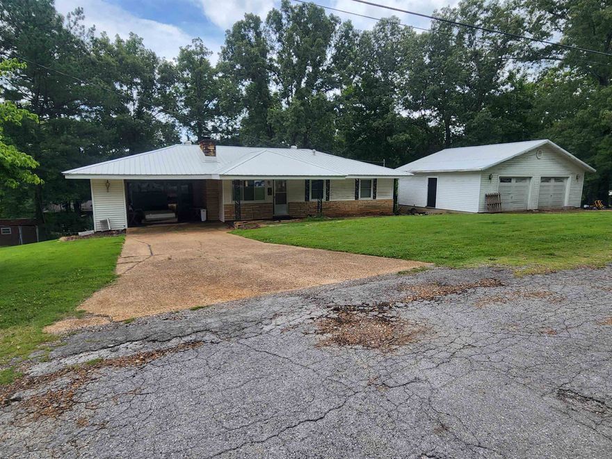 Great location. Great opportunity. This 2-bed, 2-bath home comes with 2 and 1/2 Lots. It has a 3-year-old metal roof,  This house is in a quiet, desirable neighborhood, built on 2.5 lots with a 28 x 32 detached 2-car garage. Nearly 3/4 of an acre of property. This home has that country home feel but, its in the heart of the Village. 2 bedrooms, 2 bathrooms, fireplace insert with a blower, screened in sunroom, 20 x 18 carport. Less than 1/3 mile away from the Baseheart fire station. 1 mile from the Cherokee Village Town Center and Papoose Park. 1.5 miles to the Thunderbird Center on Beautiful Lake Thunderbird. Don't forget that ownership of this home comes with access to 7 lakes, 2 Golf courses and the beautiful Southfork River. Appliances have been removed. No water heater and central heat does not work. Needs some work. Sold AS-IS