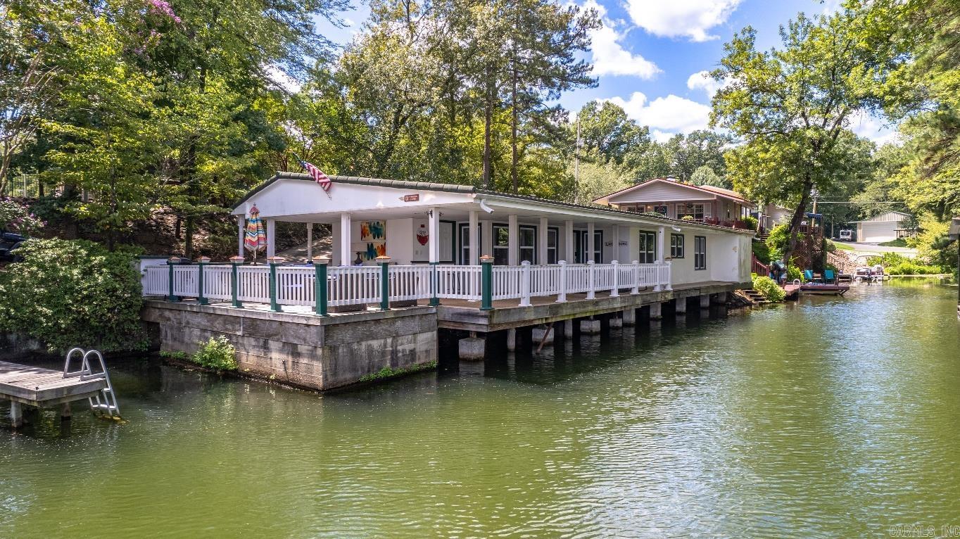 380 ft of prime Lake Hamilton property! 2 beautiful waterfront homes completely remodeled and used as short term rental properties. High income producing vacation homes with great rental history. Homes could be long term single family rentals or full time single family residence with a guest house. Dip your toes in the water just steps from the home or relax on the gorgeous lakeside patios. Outdoor kitchen areas, plenty of parking and outdoor space. There's still a lot of summertime fun waiting for you at the Lily Pad and Sweetwater Point.