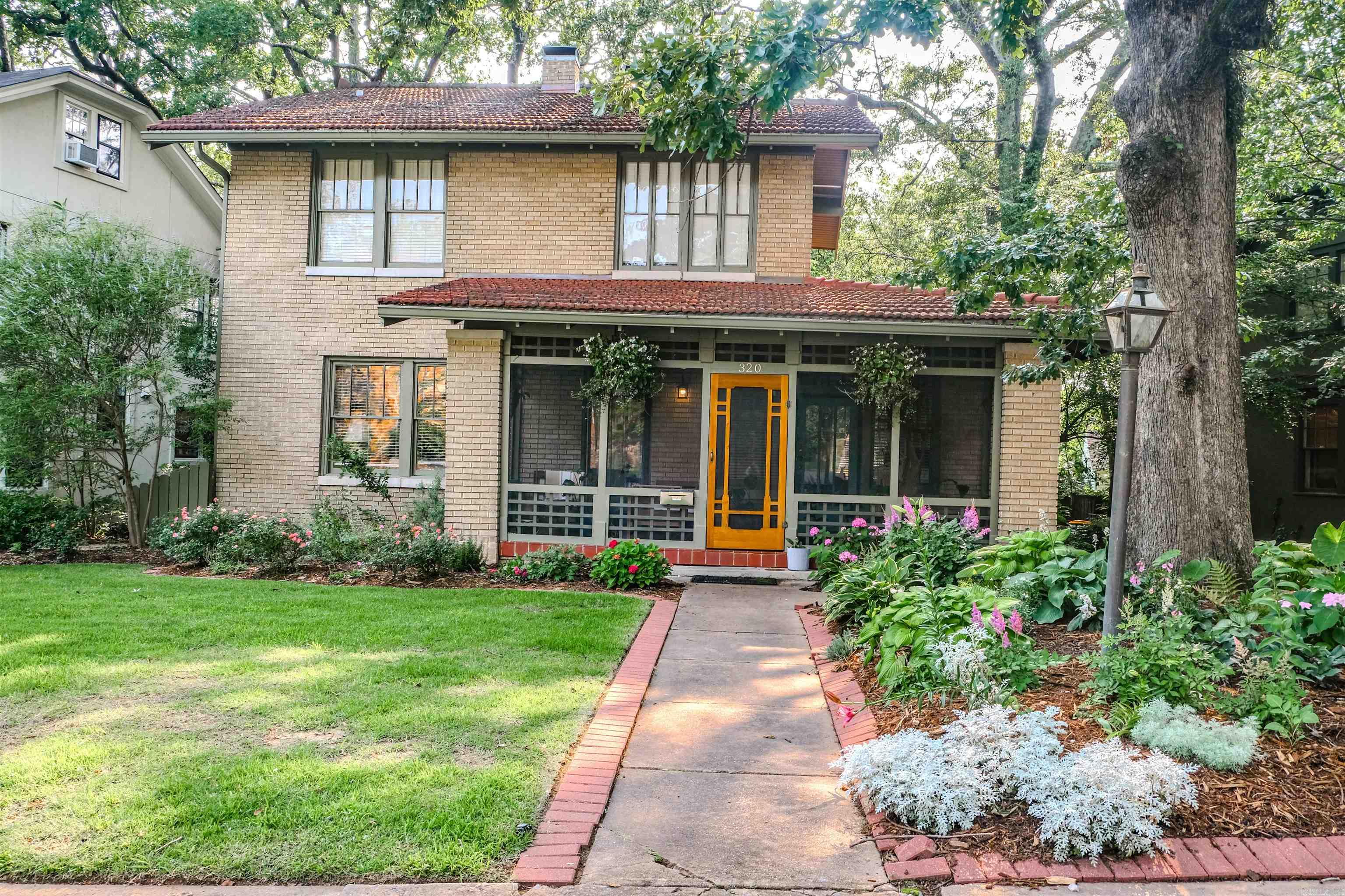 Handsome all brick Craftsman-style home with a red tile roof in Historic Hillcrest! The front door enters into a welcoming parlor and spacious formal living room with an abundance of gorgeous original windows (insulated by removable storm windows), formal dining room and eat-in kitchen with French doors opening to the back deck, powder room and laundry, all on main level. Upstairs has three bedrooms, two full baths and a sunroom off of the primary bedroom. There is also an approx. 200 sf finished walk-up attic (not included in square footage) for additional den or office with large storage room. Unfinished basement is great for hobbies or extra storage. Relax on the screened-in front porch and enjoy the landscaped lawn with sprinkler system! Tile roof restored and exterior painted 2021.