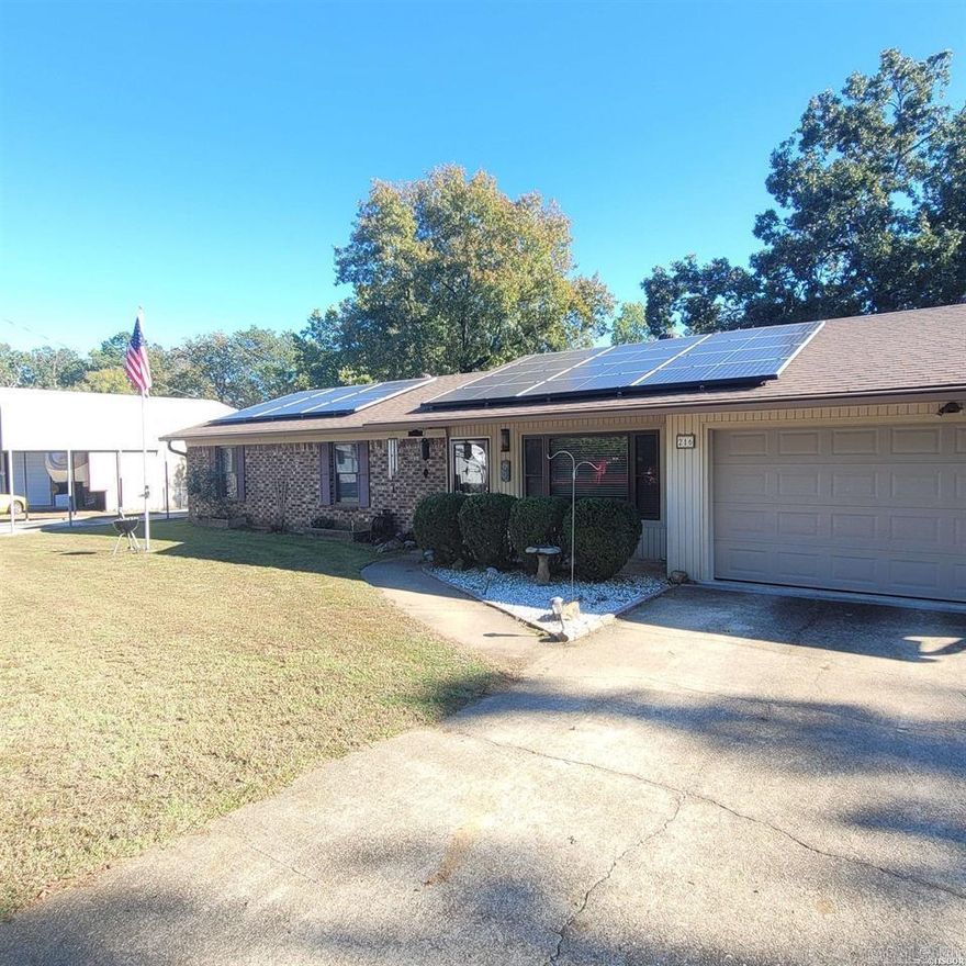 Charming 3-Bedroom, 2-Bath Home with a Sunroom, and Workshop, Sitting on Almost Half an Acre in Lake Hamilton School District with Endless Amenities!  Welcome to your perfect retreat! This inviting home boasts a peaceful, private setting, complete with a sunroom and back porch overlooking a serene backyard—ideal for relaxation or entertaining. With a newly installed roof and solar panels in 2023 (fully paid off at closing!), this home offers nearly free energy, making it an eco-friendly and cost-effective choice. The house features thermal windows throughout for improved insulation and energy efficiency, as well as low-maintenance leafless gutters to keep things tidy year-round. A spacious 2-car garage, equipped 100 amp service and 220 curcuits provides ample storage and workspace, while a propane-fueled generator ensures peace of mind during power outages. For hobbyists or those in need of extra workspace, there is a large 30X40 workshop with 220 circuits, Arcweld Welder capability and a 60-gallon compressor that will convey with the property.  Making it perfect for any project. Don’t miss out on this incredible opportunity—schedule your showing today!