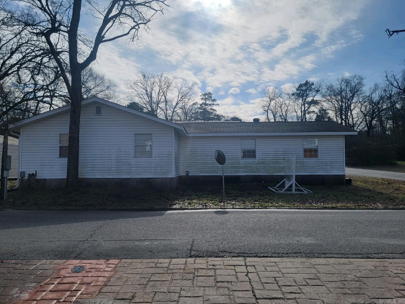This centrally located property sits on just under 2 acres. Located in an area of homes and lake condos, it is just minutes from Lake Hamilton, shopping, and dining. The property currently features a 2,128 sf +/- building that has previously been used as an office, but could easily be converted into a residence as it does feature a full kitchen and a full bath. This property is zoned PD (Planned Development), so the possibilities for development are endless with approved use from the city of Hot Springs.