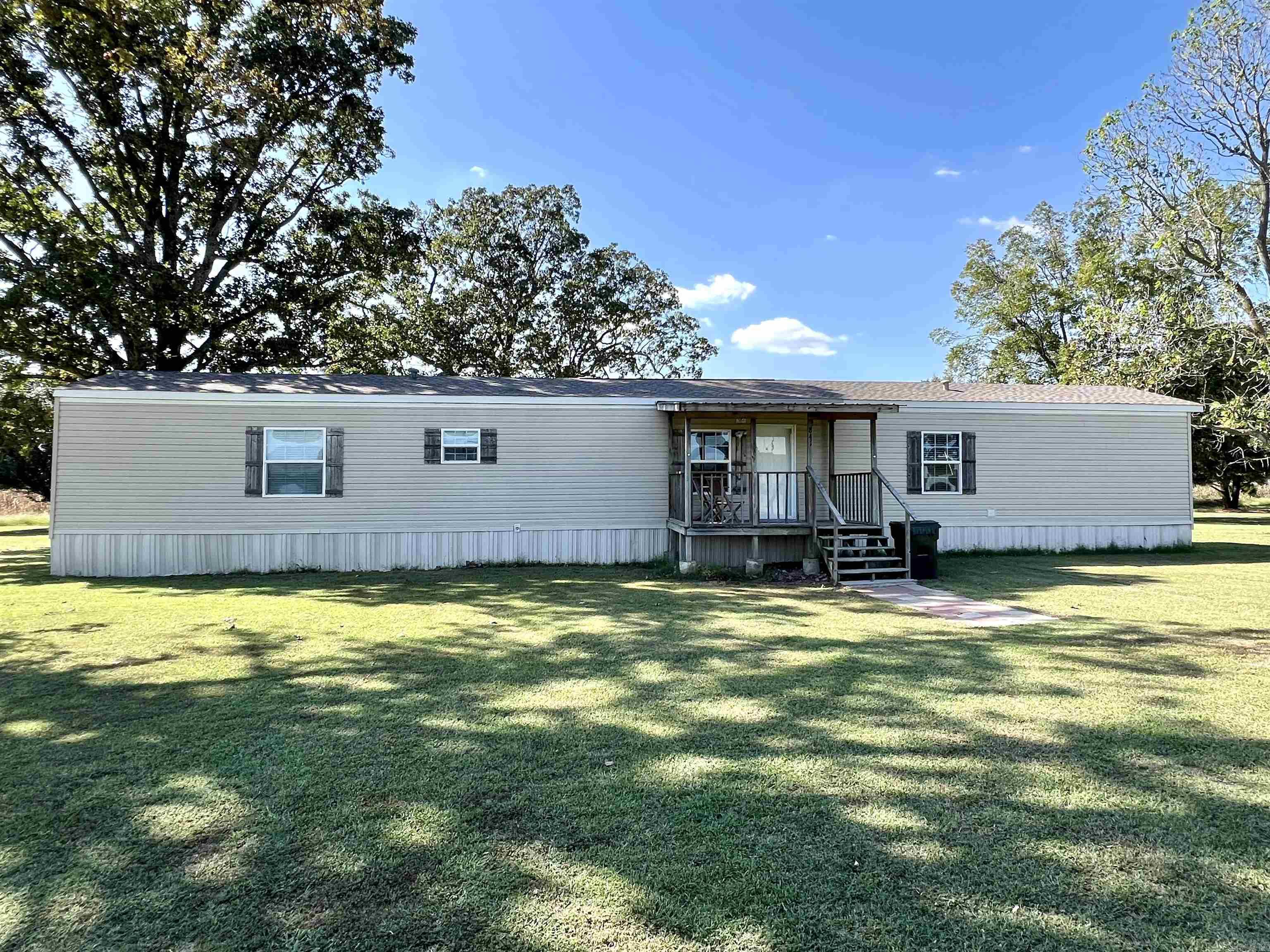 NEW ROOF installed 10/3/24 on this affordable find in Westside School District! This 3 bedroom, 2 bath home has a cute covered deck and spacious acre yard. The kitchen and living areas are open and share a vaulted ceiling. Rustic cabinetry, farmhouse sink and large island make this kitchen spectacular. The primary suite features a nice soaking tub, separate glass door shower, double vanity and walk-in closet. Two other good size bedrooms round out this split plan. One flooring throughout, no carpet. Located on pavement. Should work for FHA financing. 841 County Road 380 Bono AR is a must see.