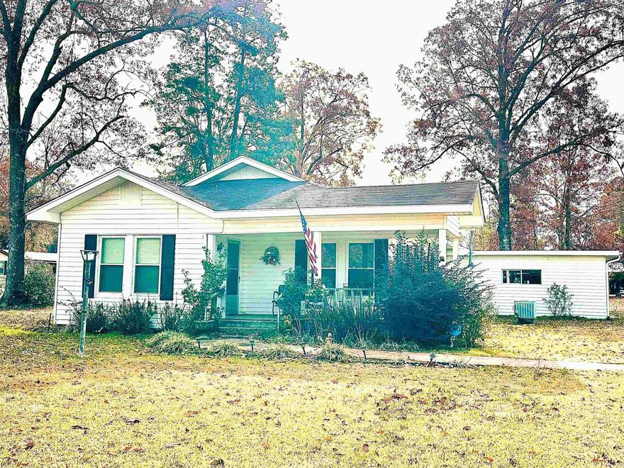 This home is located in West Crossett and sits on 2 acres.  Cute and cozy! Primary bedroom is large with great closets and attached bath, with tub/shower combo.  The other two bedrooms are also good size.  Features a dining room, open to the living area. (Chimney was removed, fireplace is inoperable) Brand new vinyl flooring in living room, dining room, hall, one bedroom and kitchen. Large laundry/storage room at the back of the home.   Concrete patio area, the craft shed will convey with the property. Property also has a circle drive that leads out to Thurman Road. Home has city water, natural gas and septic system.