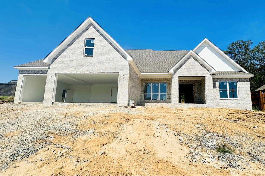 Last new home in Winterbrook one of Conway’s most desirable subdivisions. Timeless design meets modern comfort. A grand entry opens to 9' ceilings and living space filled with natural light from oversized windows. Engineered hardwood, custom stained cabinets, and quartz counters run throughout. The U-shaped kitchen is a true centerpiece with a 7' island, LG smart appliances, and walk-in pantry with counters plus garage-to-pantry access through a Costco door. Living and dining showcase a gas log fireplace with custom built-ins and stained floating shelves. The primary suite offers two closets and a spa-like bath with freestanding tub and glass shower. Upstairs adds a bonus room and full bath. Mudroom lockers and laundry cabinetry provide extra storage. Outdoor living shines with an oversized covered patio framed by cedar posts and upgraded landscaping. Every detail is designed for effortless living - enjoy a home that feels custom without the wait. Premium upgrades include a 3-car garage with EV charger, smart openers, smart thermostat, and tankless water heater with recirculation loop. 2-10 builder warranty included. Still time to personalize with quick offer. Call for specs list.