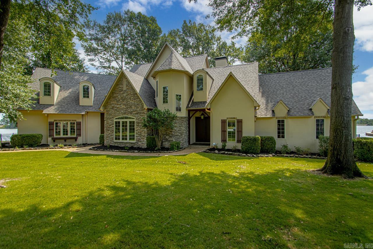 Custom built home nestled in a serene cul-de-sac overlooking Hurricane Lake, this spacious home offers luxurious living with panoramic views. Boasting 4 bedrooms, 3.5 baths, including a private upstairs suite with a kitchenette, balcony and full bath, ideal for a game room or guest retreat. The primary bedroom has an office overlooking the lake with floor to ceiling windows brining the outside in, spacious walk in shower and jacuzzi tub. A cozy fireplace complemented by floor-to-ceiling windows in the mezzanine living room and built-ins. chef's kitchen that includes a large breakfast bar, pantry, while ample storage is provided, this home has a floored walk-in attic for tons of storage. Large utility room with storage and sink. Home has gorgeous separate dining room off the living area with buffet. Outside, enjoy the wrought iron fence and dock with seating area along with a bulkhead sea wall, ensuring both privacy and waterfront access. This beautiful home all sets on a spacious lot with no neighboring homes on either side in view from inside the house. Additional amenities include a 3-car garage with storage, new roof in June 2024. Agents see remarks. Elevation Survey in Docs.