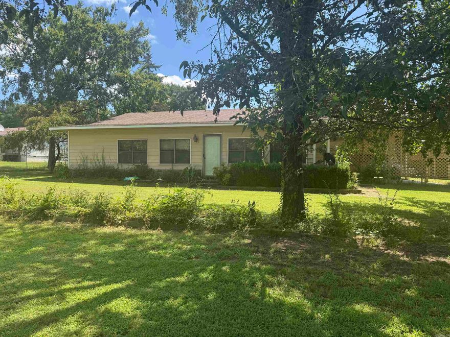 JUST STEPS FROM SHOAL BAY PARK ON LAKE DARDANELLE, with easy access to the boat ramp, fishing, camping and outdoor recreation.  This spacious 1828 sq.ft. home features a kitchen with ample cabinets and counter space for party planning. oversized bedroom with attached bathroom, a huge sunroom ideal for game room, and additional living space.  RV/Boat pad located at the south end of the the main house.  All situated on a private, spacious 1-acre lot. With a 30X40 metal shop in the backyard. Whether you're looking for a full-time home, a weekend lake retreat, or an investment opportunity with rental potential, this one-of-kind property has it all!