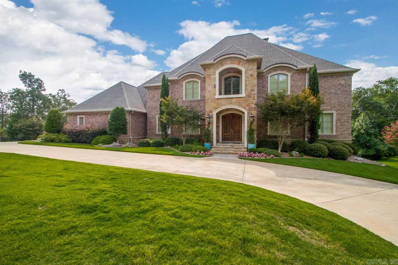 Rare find on over an acre+1/2 in a desirable, gated neighborhood. Convenient to shopping w/ easy access to interstate. 3 level, spacious home w/ designer finishes. Master+ guest suite on main level. Large eat in kitchen with wet bar and 2 breakfast bars. 20' ceilings in Foyer+ living rm. Downstairs has a BR suite, workout room, 1/2 bath and separate living space great for teens or in law quarters. Upstairs has 2 BR suites , theater rm. and a bonus rm. New pool liner, lighted sport court added in 2012