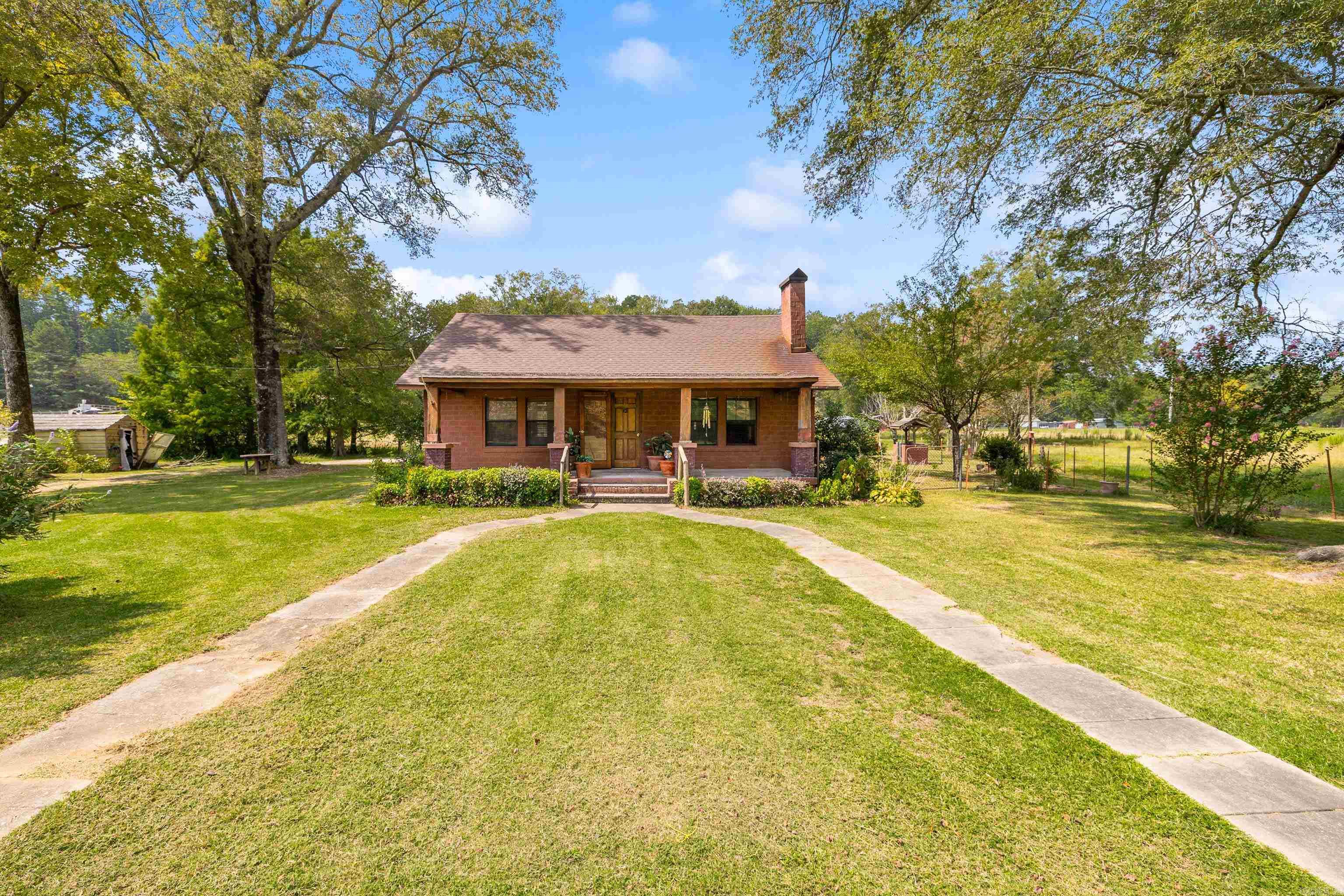 Welcome home to your very own farm house at 14124 Highway 67. This 1750 sqft home offers an inviting floor plan full of charm and warmth with 3 beds and 2 baths. Cook your favorite meals in the custom kitchen, with real oak cabinetry, custom horseshoe pulls and a pantry with an antique door! Gorgeous landscaping gives the ultimate curb appeal. Side yard offers a goldfish pond and is fenced separately for convenience. Enjoy 7.71+/- acres, including a fully fenced pasture suitable for livestock. There is a workshop with lean-to shed perfect for storing tack, lawn equipment or tractor. There is a horse barn located near the back of the pasture. If your dreaming of living the farm life, this may just be the farm! Come see this incredible property today.