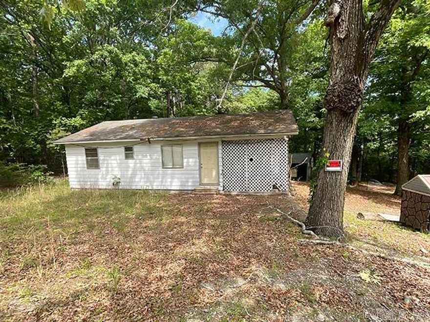Opportunity awaits on approximately 1.25 wooded acres. This 2-bedroom, 1-bath home offers privacy, space, and potential at an affordable price point. Tucked among mature trees with room to spread out, this property is ideal for buyers looking for land, investment potential, or a project with usable outdoor space. This is a rare chance to own acreage and a shop in Little Rock at an accessible price. Just 15 minutes from the heart of town! No seller property disclosure. Buyers are encouraged to measure lot size and home square footage for themselves. Property is being sold as-is/where-is.