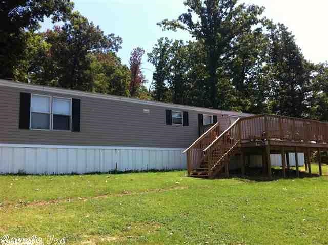 Peaceful serenity is what you will find tucked away on Crowley's Ridge with this 3 bedroom, 2 bath mobile home located between a hillside of woods and big boulders, with a gorgeous view all from your front deck. All electric home, carpet and vinyl, custom cabinets, built-in shelves and drawers in bedroom. Sits on paved road. The master bedroom has a walk-in closet, large tub. Split floor plan. Deck on back. 15x20 metal shop with roll top door on concrete. Schedule your personal tour today!!