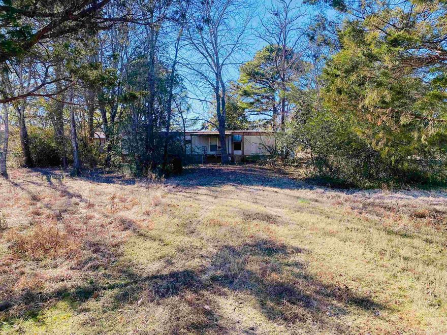 Lot available blocks from Lake Conway. .86 acres. Lot has trees and cleared space. Partially fenced. Mobile home and storage building on property to convey at no value.