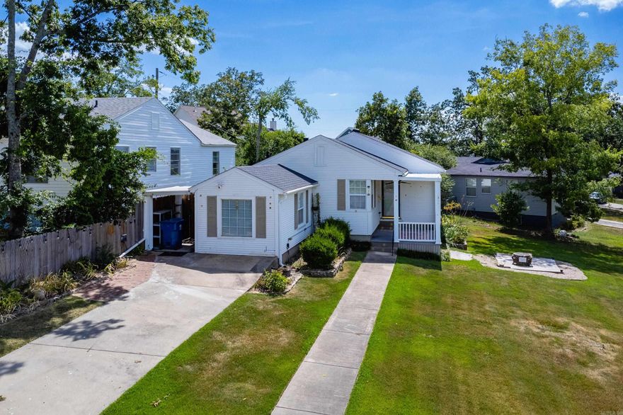 Adorable bungalow on a large corner lot with plenty of charm and potential. Hardwood floors run throughout the living spaces, with tile in the kitchen and bath. The compact kitchen opens to a nice living area with space for a dining area. Home offers three nicely sized bedrooms and a central bathroom featuring a large walk-in shower. Separate laundry with extra storage space. Enjoy the sweet covered front porch, back deck, and two storage buildings. One car carport and long driveway. Come see.