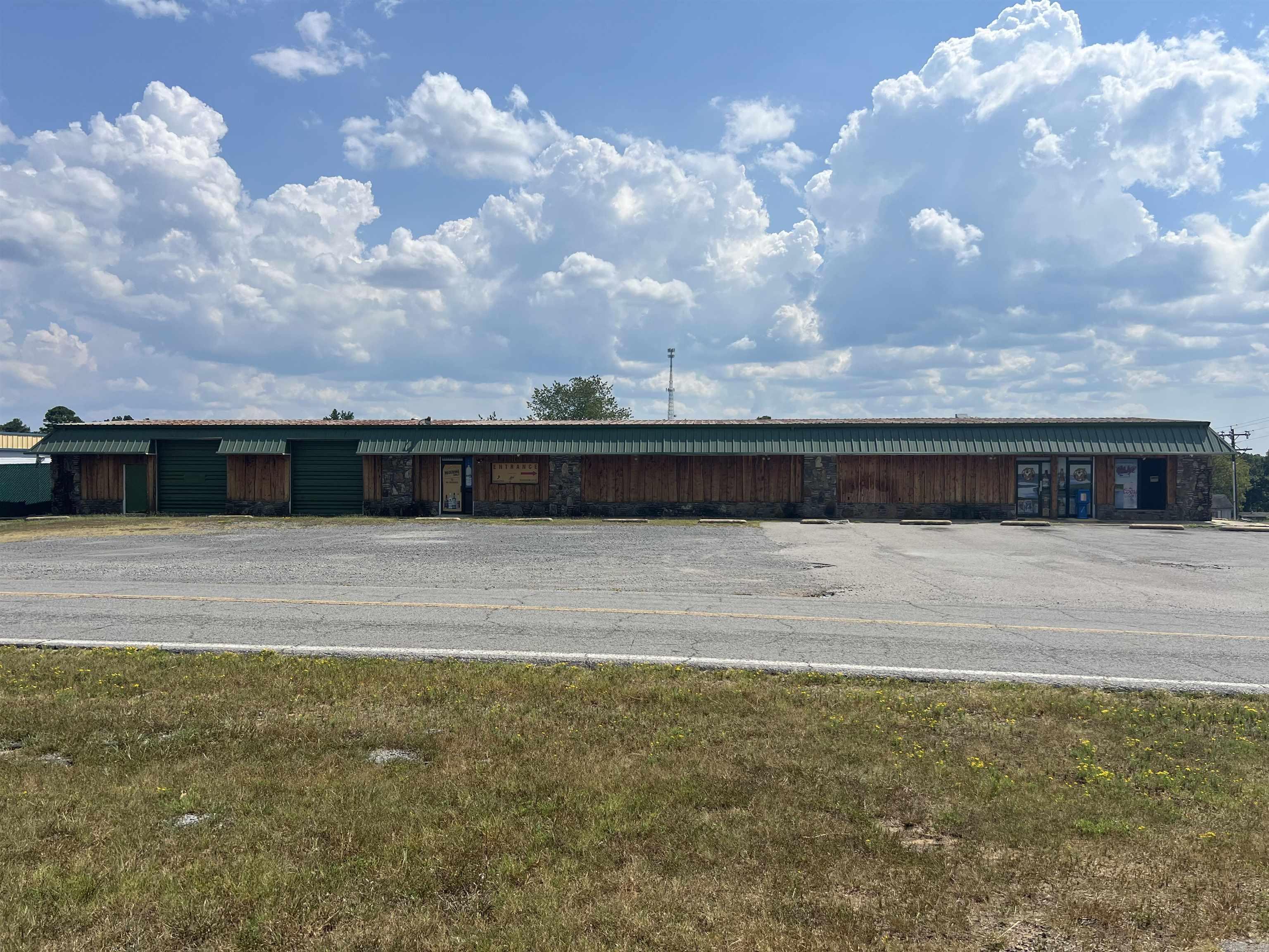 Attention Investors, Corporations, Entrepreneurs!!! Commercial Building and Land suitable for several potential income producing opportunities! This space is ready for someone with a great vision. This space is big enough to be another restaurant, convenience store, or indoor climate controlled store units. This building used to host a convenience store, liquor store, & offered units to lease as retail spaces. The inground fuel tanks, pumps, & canopy (which was replaced in 2020) are still there to bring a convenience store back to life in an area w/limited competition & at a high traffic 4-way stop intersection of Hwy 330 & Beaver Road. The tanks are ACT 100 tanks w/ 2 having an 8,000 gallon capacity & 3rd is 6,000 gallons. The suppresser system remains from when the store served food. Building comes with a 30 ft x 8 ft walk in cooler with 11 glass doors. The building has around 4,200 Sq feet of heated & cooled space w/(3) 5-ton commercial HVAC units installed in 2022, plus an additional 1,760 sq feet of warehouse space that was once a mechanic's shop. Best part is its only about 1 mile to Marina. People will definitely stop to fill their boats with cheaper fuel.Cameras do convey.