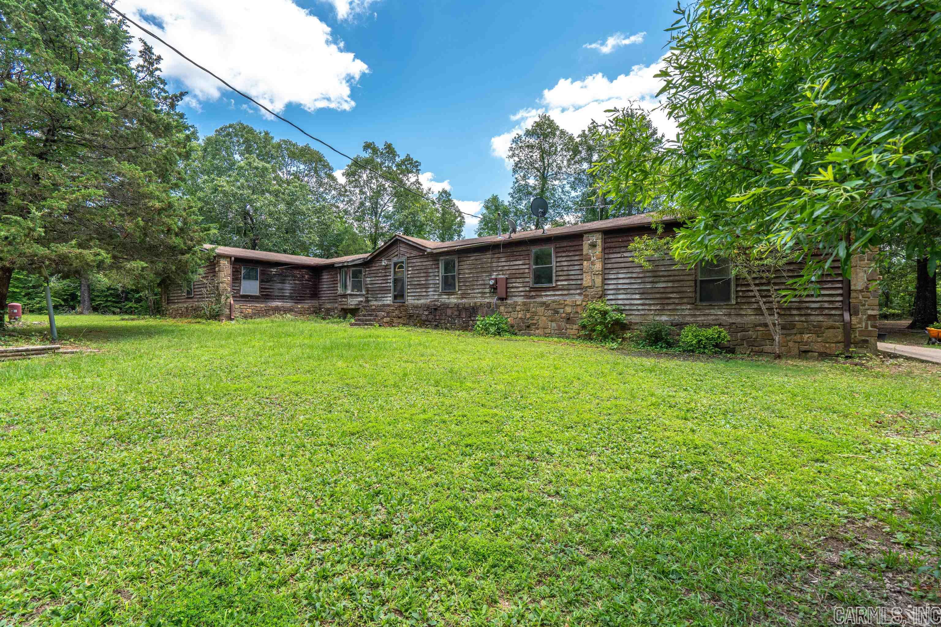 Close to town and still in the country. 3 bedroom 3 bath on 9.45 acres, the home has plenty of storage, office and family room. So many possibilities with some tlc.